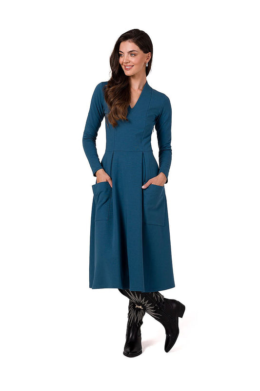 Elegant BeWear Daydress featuring a deep V neckline, chic long sleeves, and a pleated skirt, perfect for sophisticated occasions.