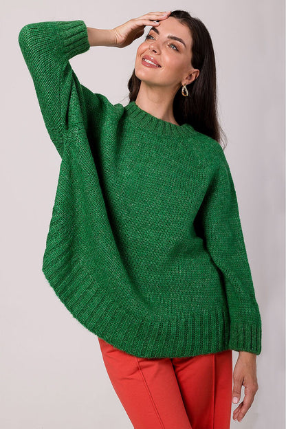Luxury women's oversized knit jumper with batwing sleeves in soft ribbed yarn, designed for elegance and comfort.