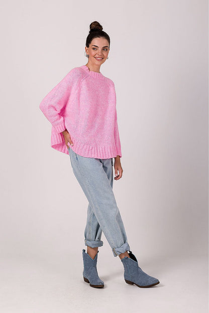 Versatile women's oversized knit jumper, elegantly styled with jeans for a luxury casual look, featuring a unique batwing sleeve design.