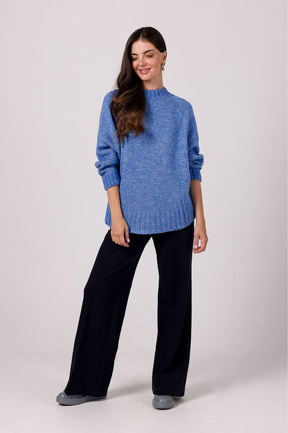 Elegantly draped women's batwing sleeve oversized knit jumper worn with denim, illustrating versatile styling options for casual chic outfits.