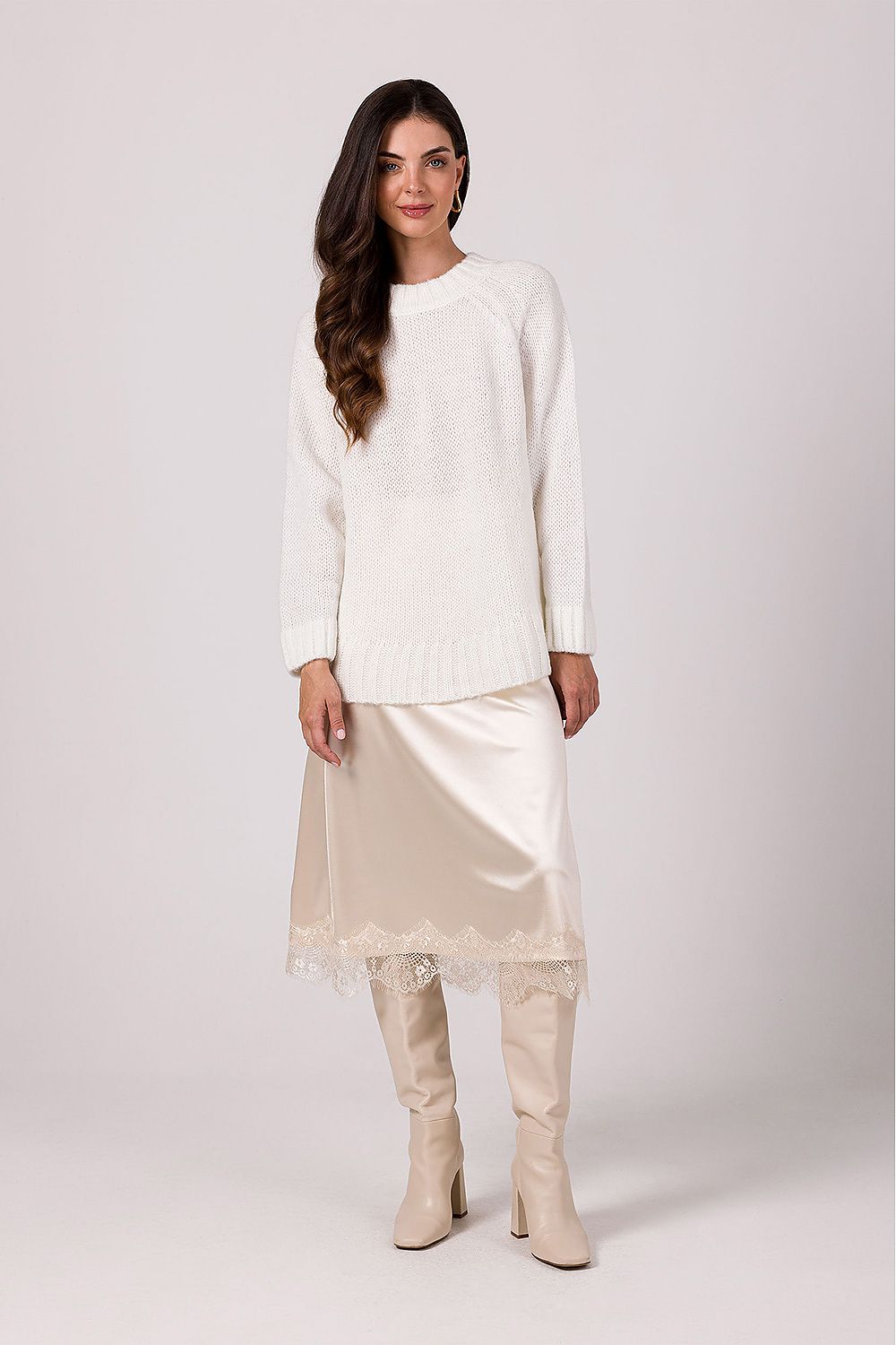 Stylish women's oversized knit jumper displayed on a model, highlighting its flattering loose fit and modern batwing sleeve design.