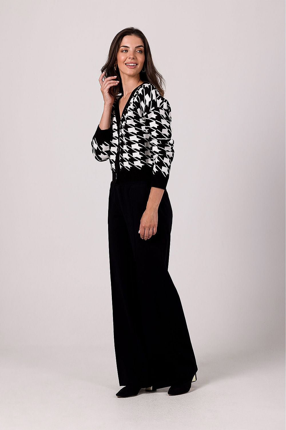 Full view of the BE Knit Cardigan on a model, emphasizing its ribbed hems and stylish lowered shoulder design, ideal for fashion-forward individuals.