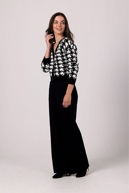 Full view of the BE Knit Cardigan on a model, emphasizing its ribbed hems and stylish lowered shoulder design, ideal for fashion-forward individuals.