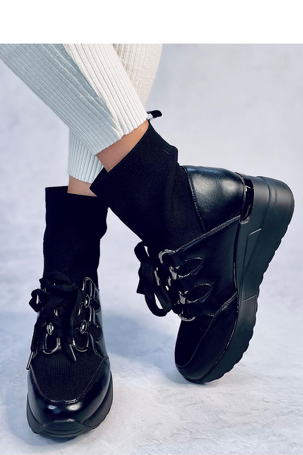 Close-up view of Inello women's buskin boots showcasing their luxurious chain detail and high-quality ecological leather material.