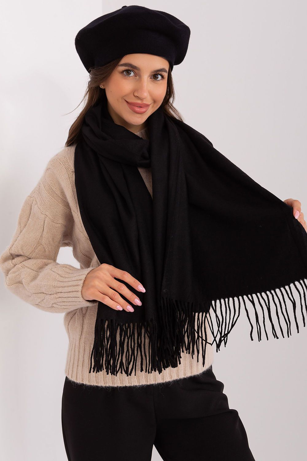 Chic polyester scarf with decorative tassels, ideal for keeping warm while enhancing winter outfits.