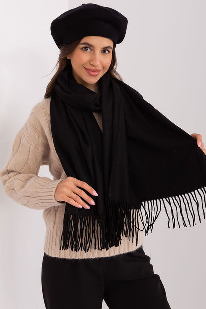 Chic polyester scarf with decorative tassels, ideal for keeping warm while enhancing winter outfits.
