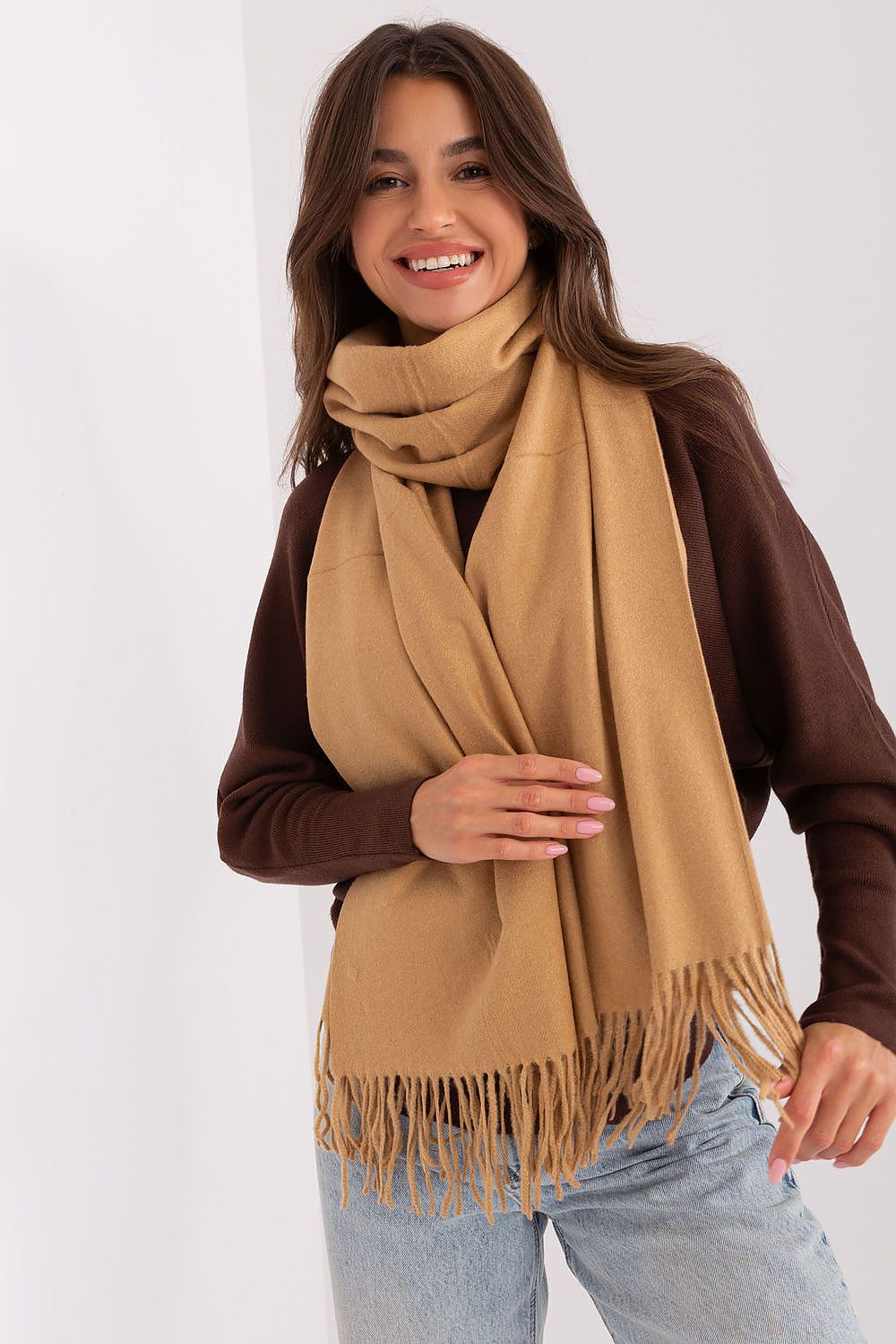 Close-up view of the soft texture of the warm polyester scarf featuring stylish tassels, perfect for winter fashion.