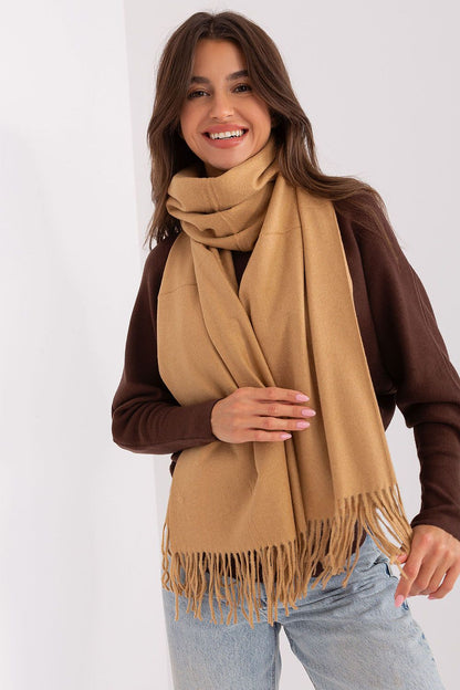 Close-up view of the soft texture of the warm polyester scarf featuring stylish tassels, perfect for winter fashion.