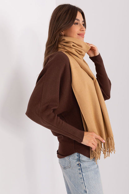 Warm luxurious scarf with decorative tassels, draped elegantly, designed to enhance winter outfits.