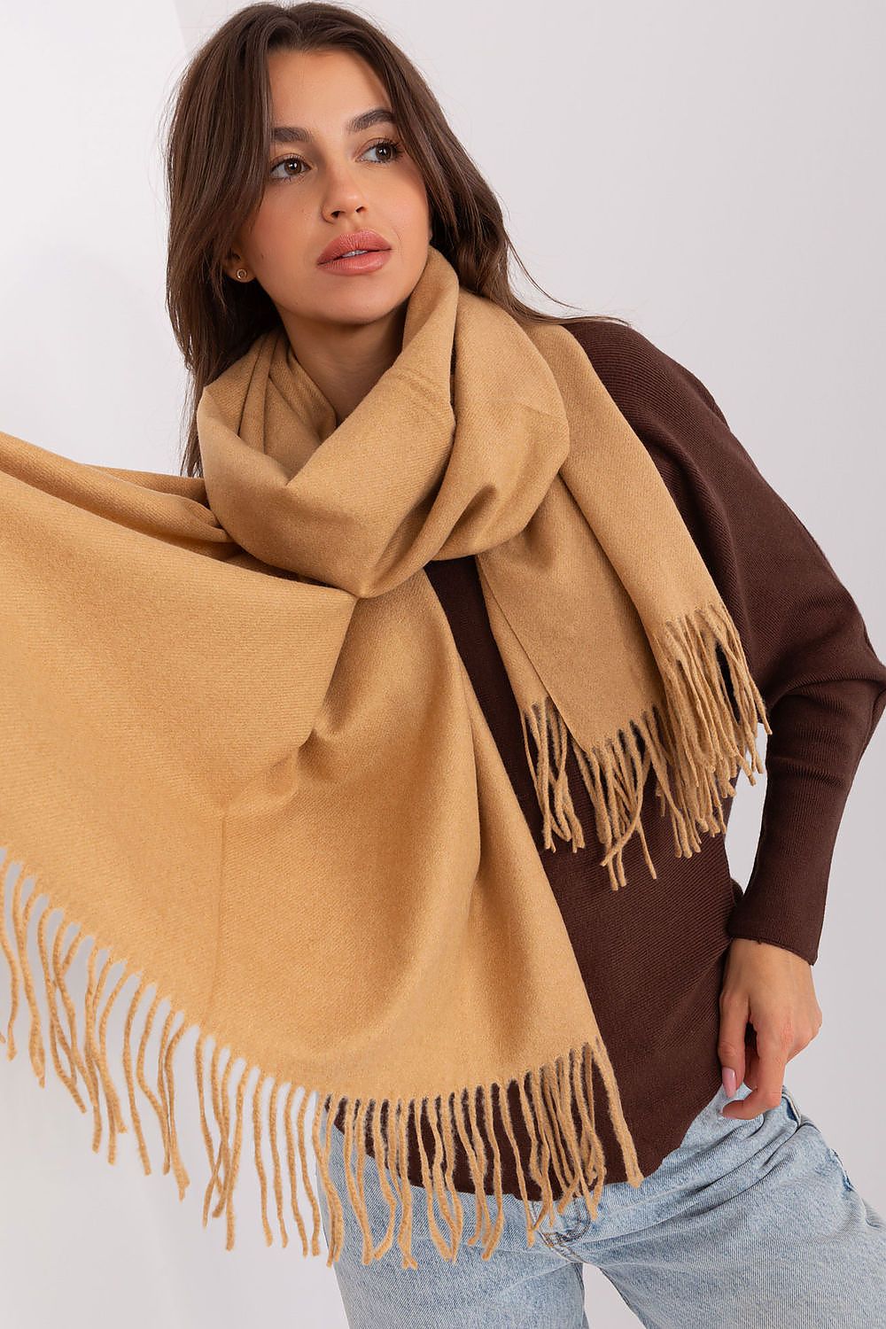 Sophisticated polyester scarf with intricate tassels, ideal for adding warmth and style to winter wardrobes.