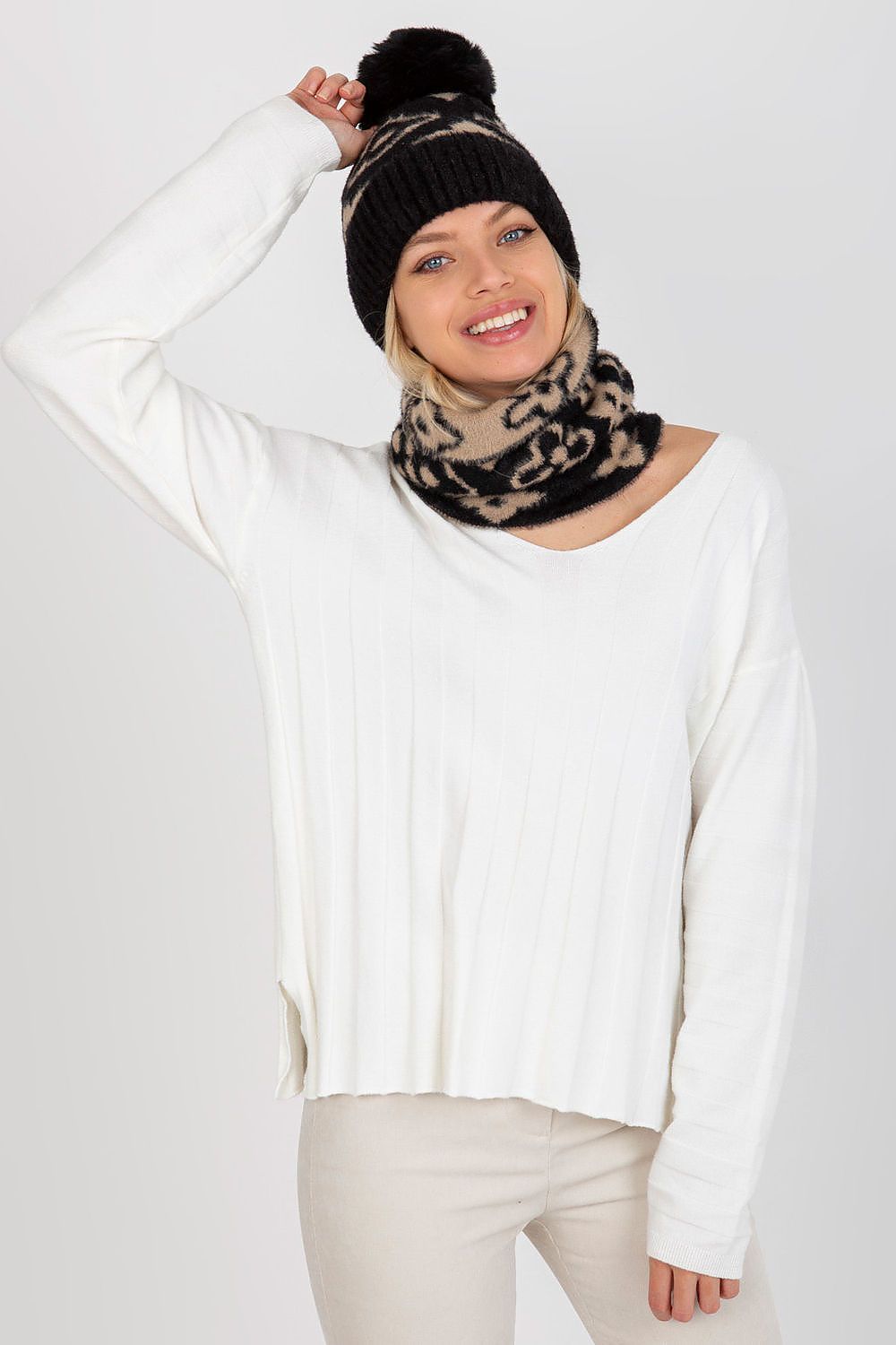 Close-up detail of high-quality acrylic fabric on a thick winter cap with pom-pom, showcasing luxury craftsmanship.