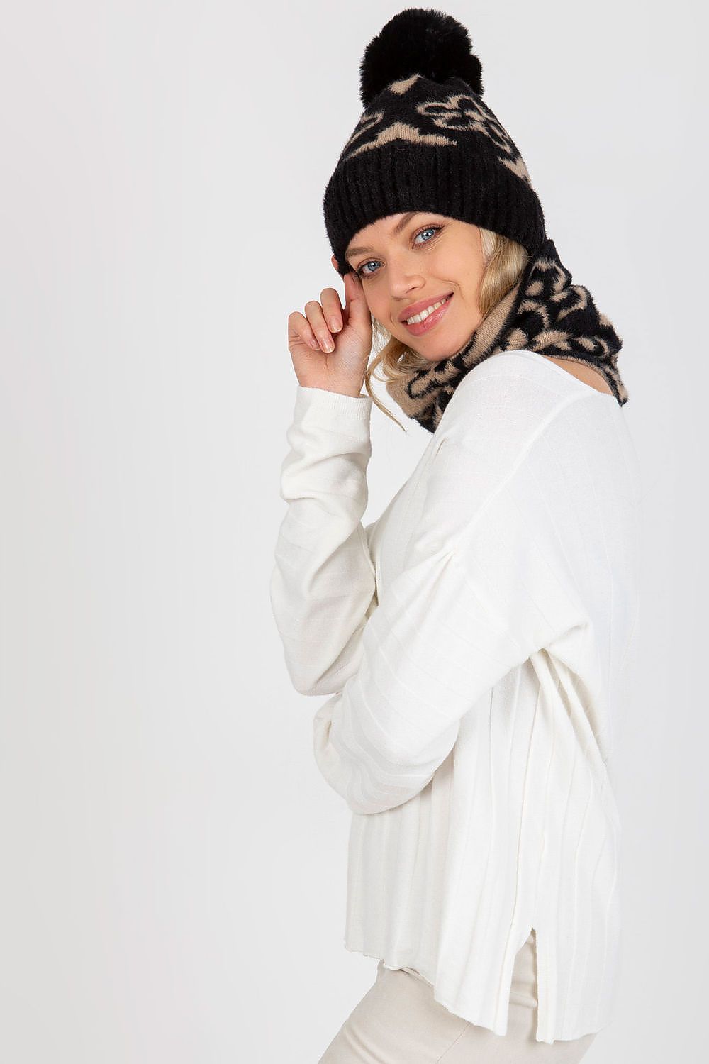 Model wearing a luxurious thick acrylic winter cap with pom-pom, exuding style and warmth in a winter setting.