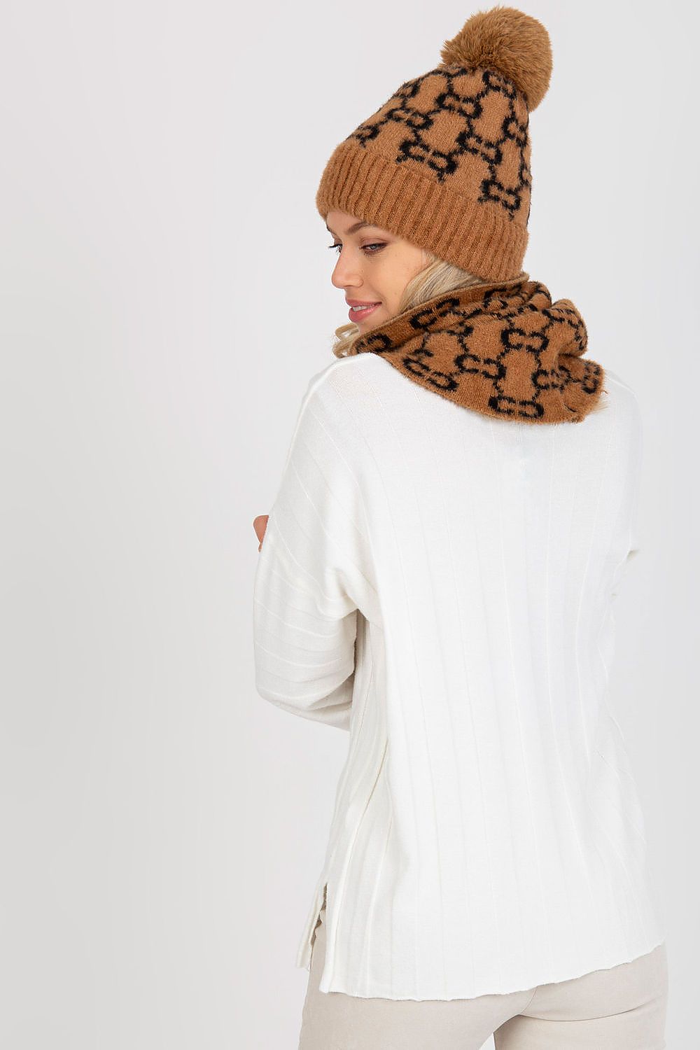 Elegant display of the infinity scarf draped over a stylish coat, highlighting its luxurious fabric and design.