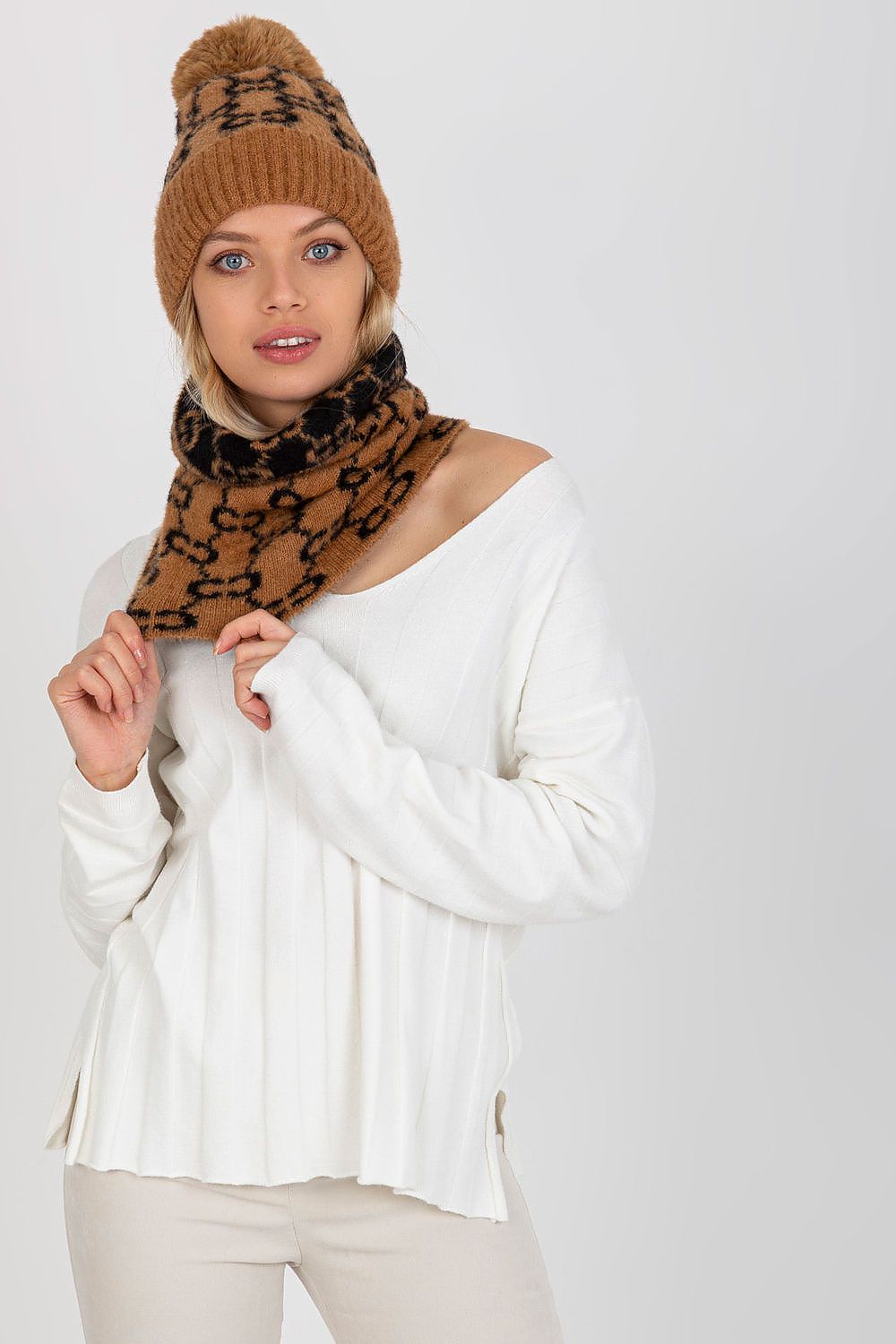 Fashion-forward model wearing the luxurious infinity scarf and matching cap, showcasing a trendy winter look.