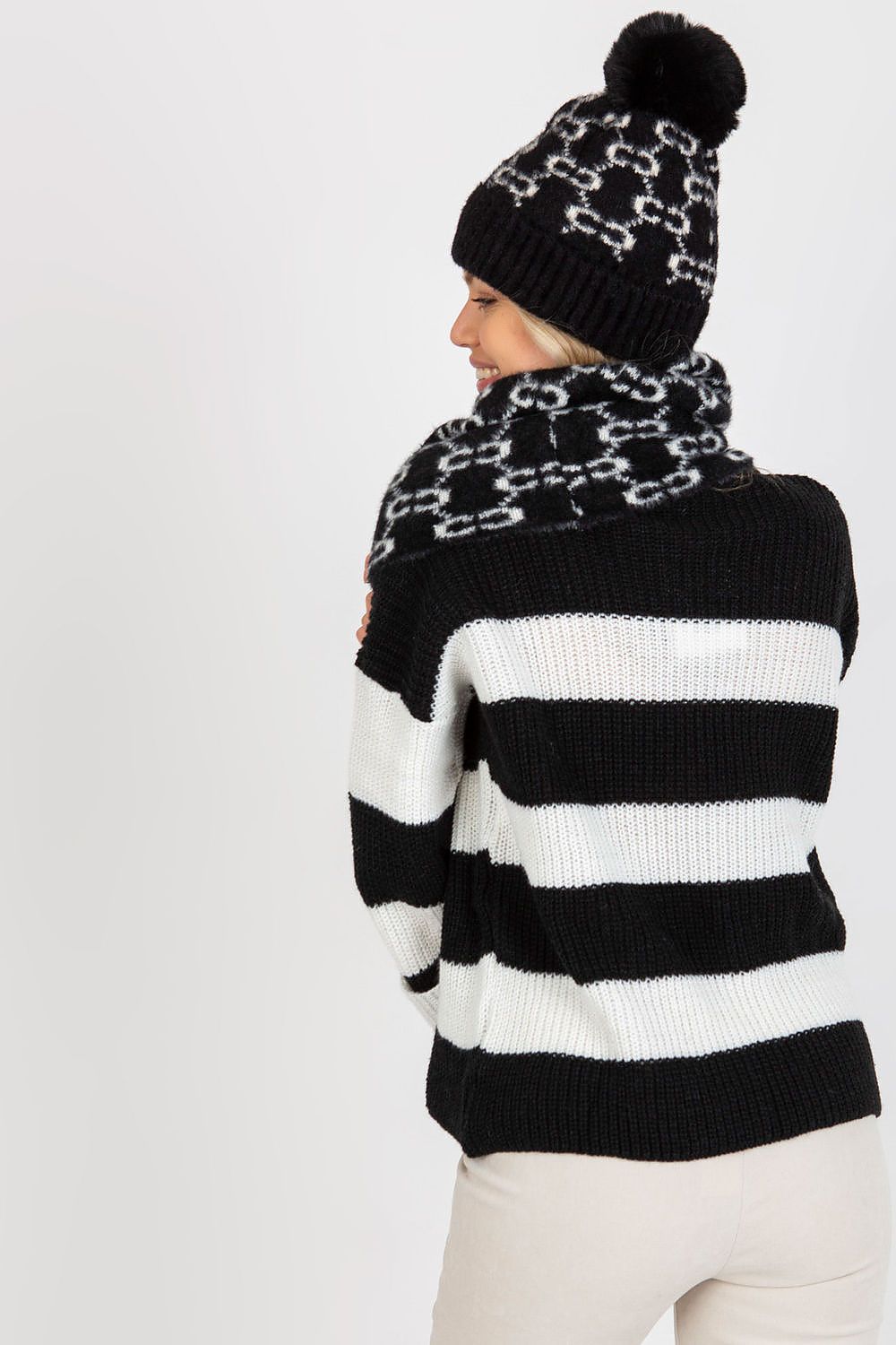 Elegant infinity scarf made from 100% acrylic, designed to be paired with a matching cap for a sophisticated winter look.