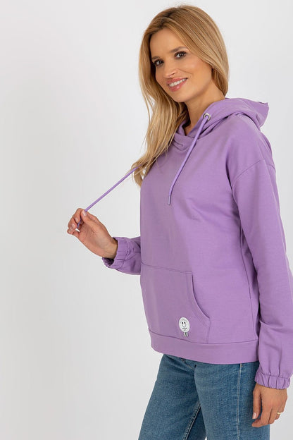 Close-up of the elegant patch detail on a cozy cotton hoodie, blending fashion and functionality seamlessly.