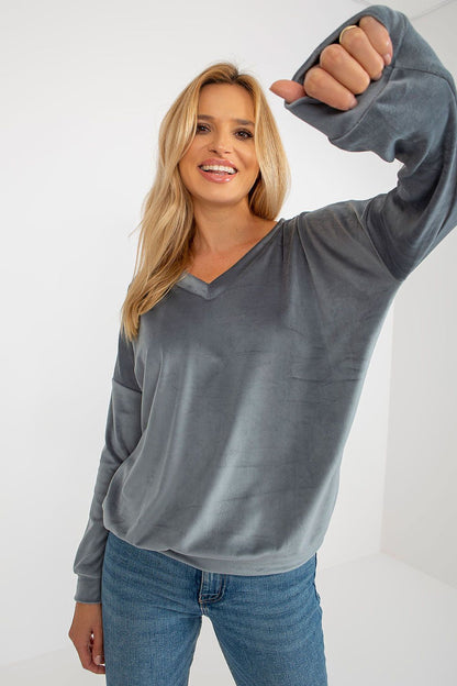 Close-up of the soft, smooth fabric of a luxury velour sweatshirt, showcasing its comfort and elegance.