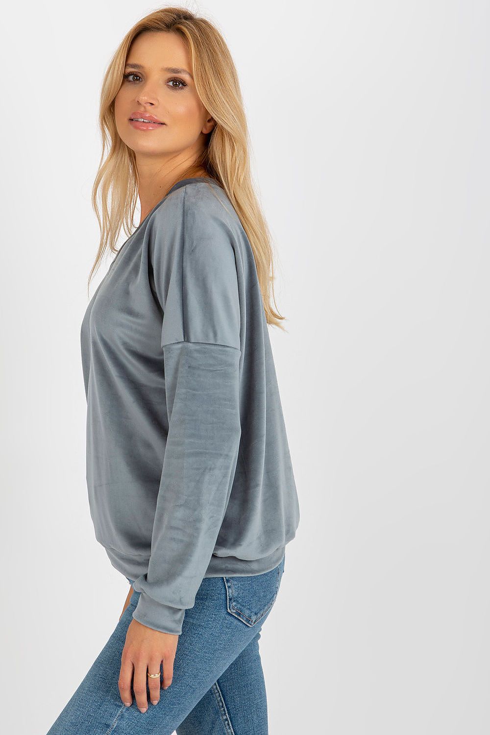 Stylish model wearing a luxury velour sweatshirt with a V-shaped neckline, highlighting its versatility for various outfits.