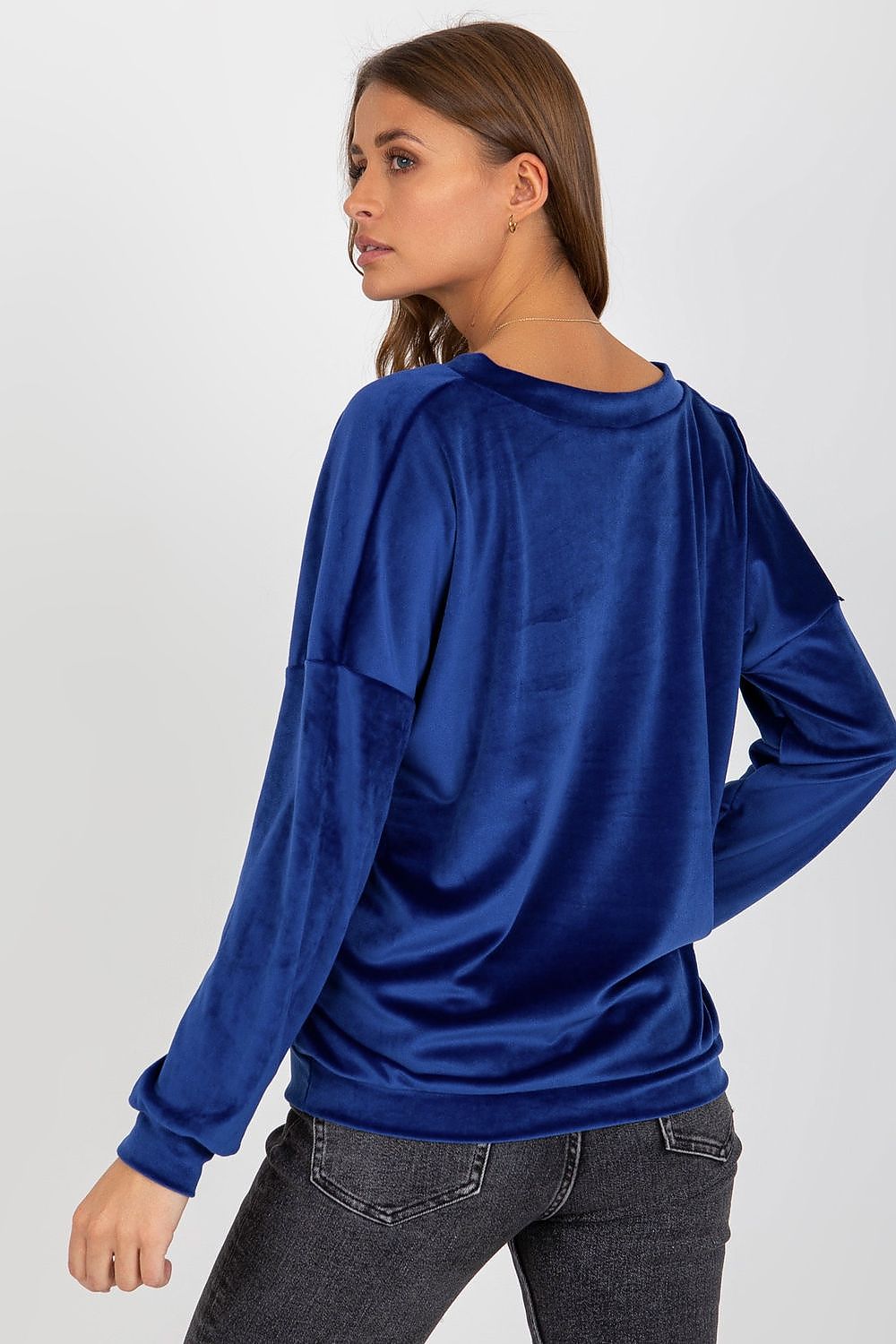 Model wearing luxury velour sweatshirt with V-shaped neckline, demonstrating a chic casual look suitable for various occasions.