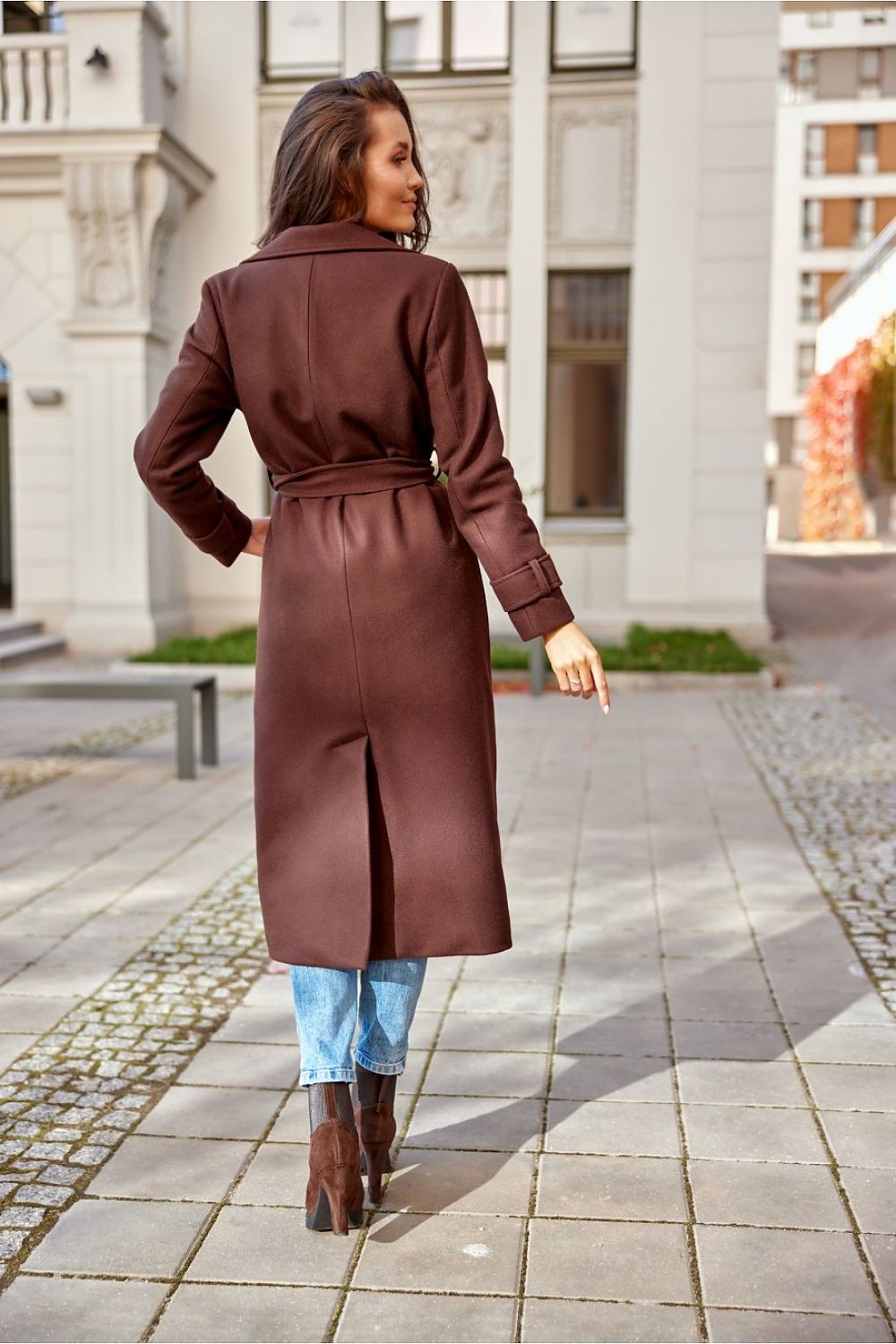 Luxurious elegant wool tie coat with pockets and back slit from Roco Fashion, showcasing timeless autumn style on a model in a trendy setting.
