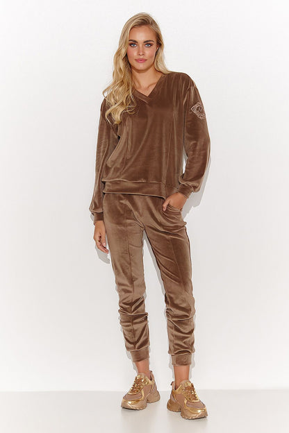 Stylish women's velvet tracksuit set with long sleeves and functional pockets, embodying luxury and versatility for any occasion.