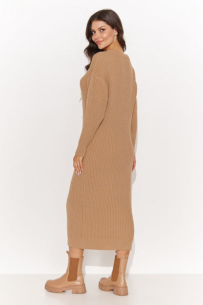 Stylish Numinou long sleeve sweater dress cinched with a thick belt, showcasing its versatility in black, ideal for both casual and formal occasions.