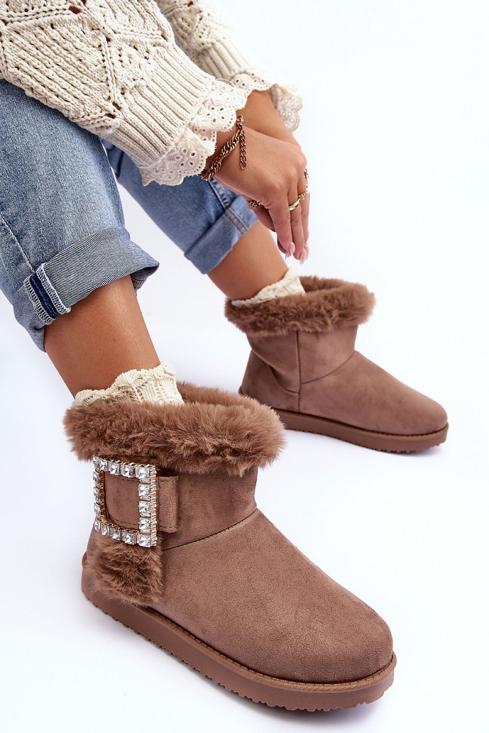 Close-up view of luxurious eco-suede snow boots, highlighting the rich fur insulation and sophisticated buckle detail for ultimate comfort in cold conditions.