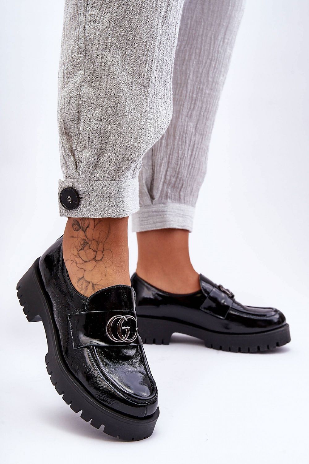 Elegant women's leather slip-on half shoes with a sleek design featuring a stable heel and platform, perfect for versatile styling.