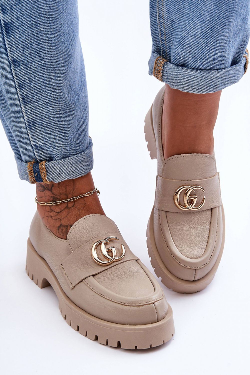 Stylish close-up of women's leather half shoes, highlighting the smooth natural leather texture and comfortable slip-on style.