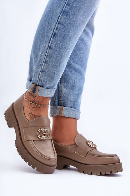 Close-up of elegant leather slip-on half shoes featuring a cushioned insole and stylish platform, perfect for chic outfits.