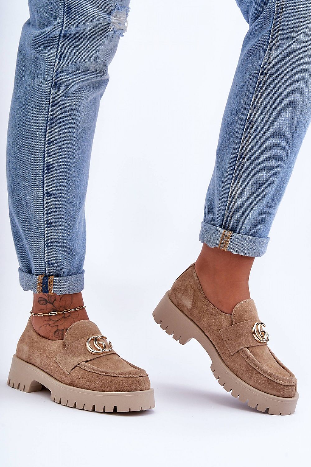 Stylish close-up of elegant women's slip-on half shoes, crafted from premium natural leather with a classic design and elastic tightening band for a perfect fit.