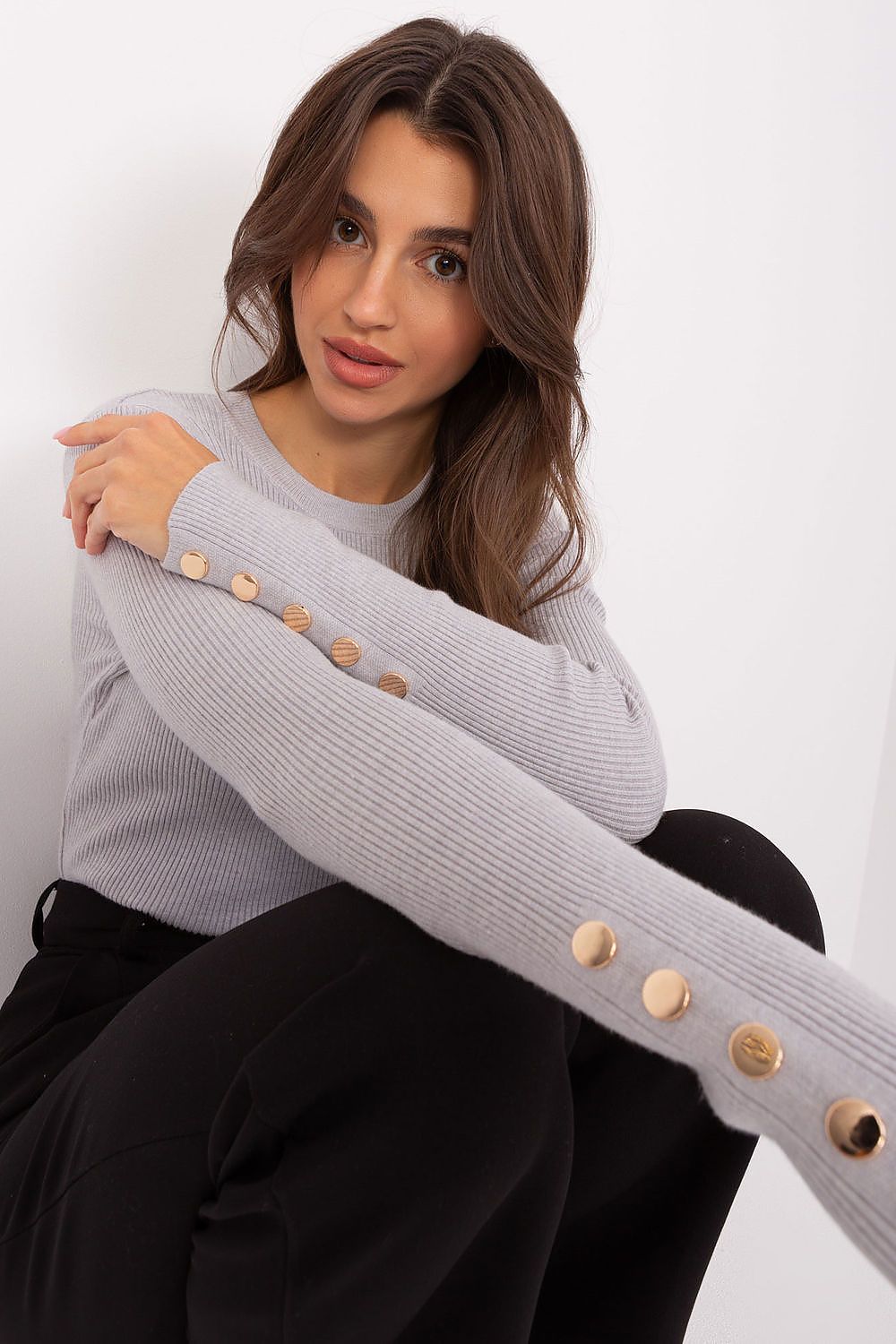 Elegant autumn/winter sweater showcasing ribbed texture and stylish button sleeve details, ideal for a chic and sophisticated wardrobe.
