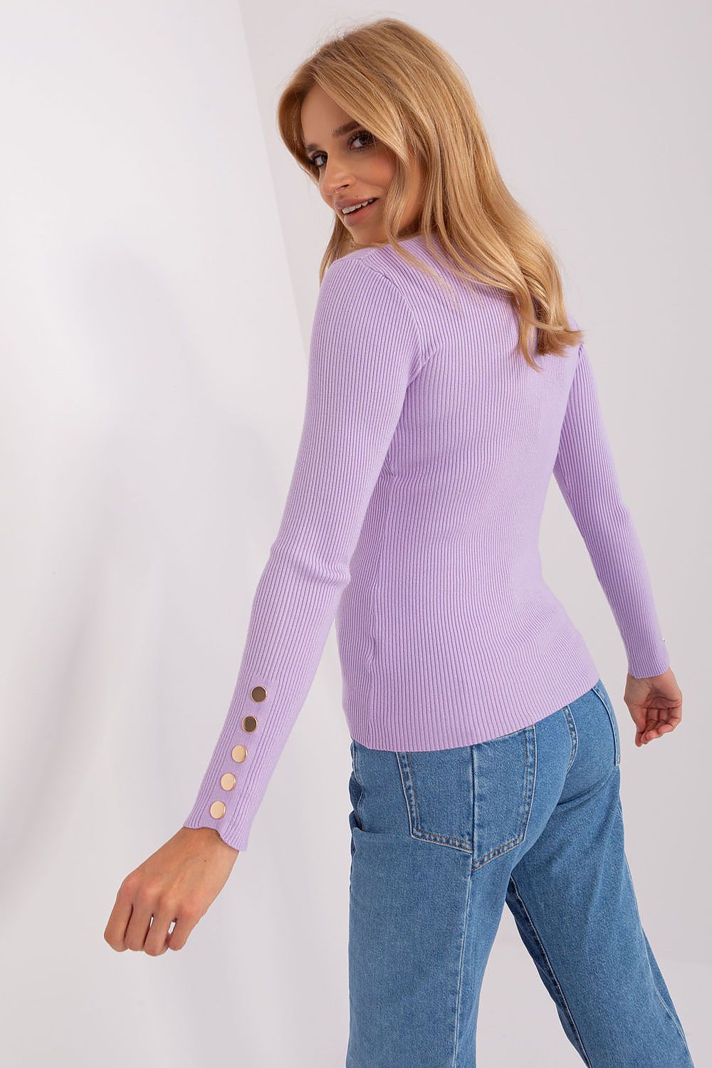 Close-up of the distinctive button details on the sleeves of a stylish viscose sweater, adding flair to a sophisticated autumn/winter outfit.