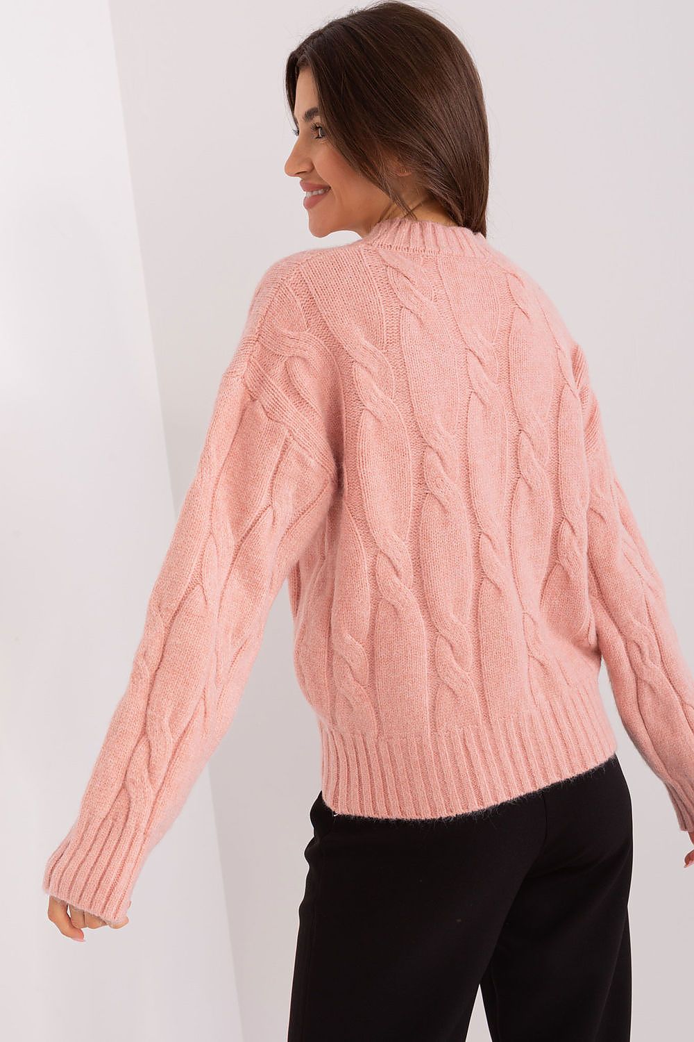Chic women's acrylic sweater styled with tailored pants, showcasing its versatility and sophistication in a contemporary outfit.