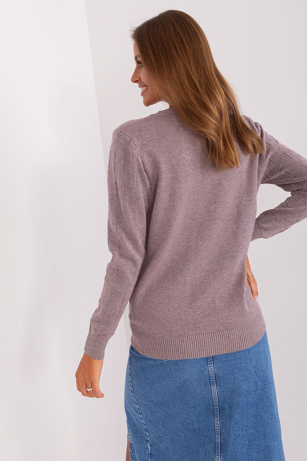 Luxurious close-up of stylish women's cotton-blend jumper, showcasing its soft fabric texture and sophisticated pattern.