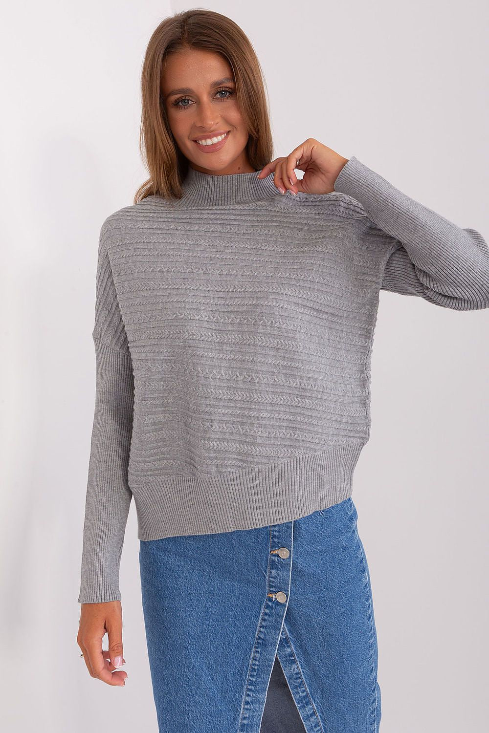Stylishly paired women's variegated knit sweater with jeans, perfect for a casual yet sophisticated look.