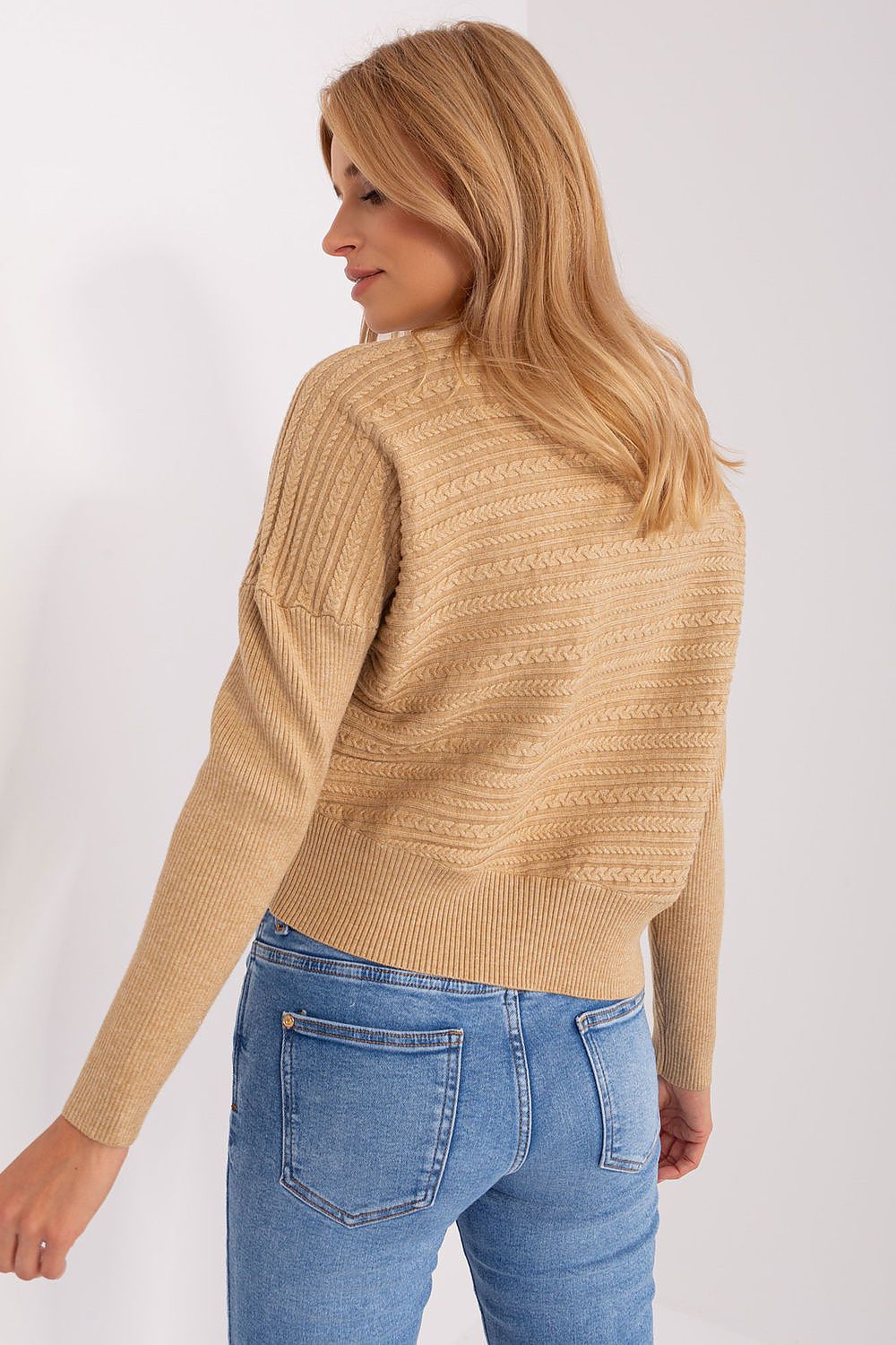 Elegant women's long sleeve sweater with low turtleneck in a cozy setting, exemplifying comfort and luxury combined.