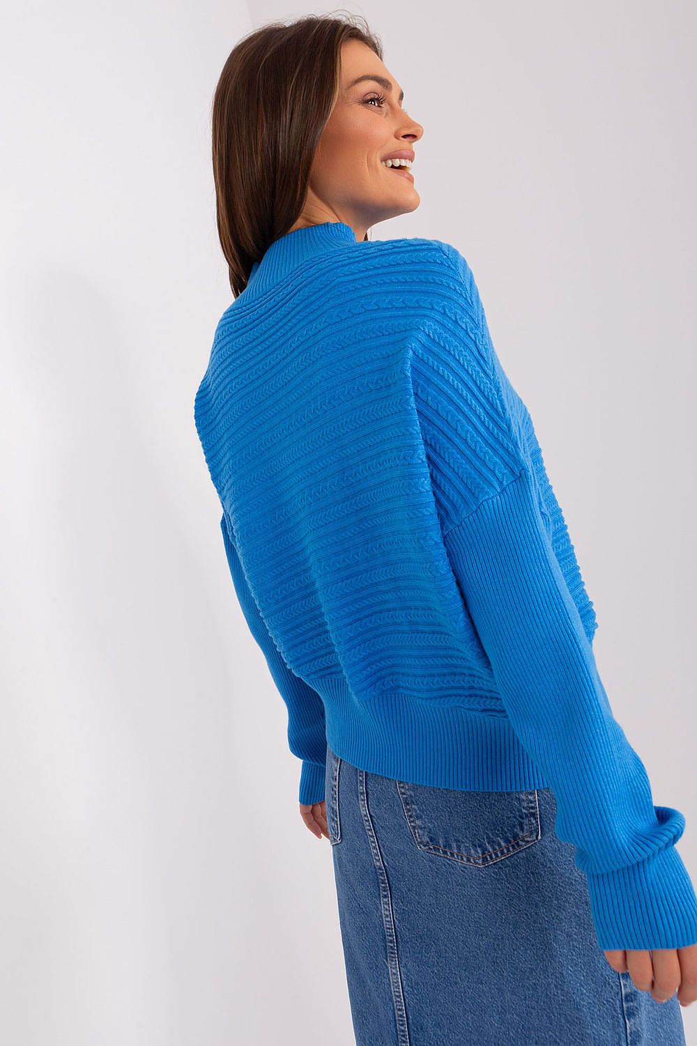 Fashion-forward styling of the variegated knit sweater, paired elegantly with jeans for a chic and comfortable outfit.