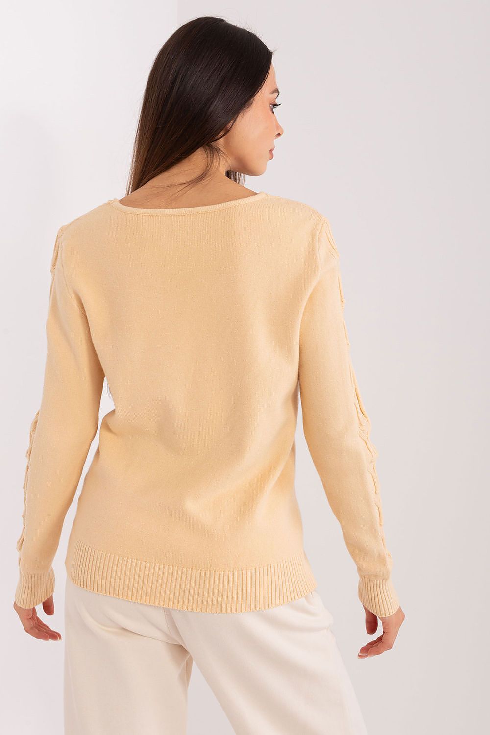 Chic women's V-neck jumper styled with jeans, demonstrating its versatility for casual outings or relaxed office wear.