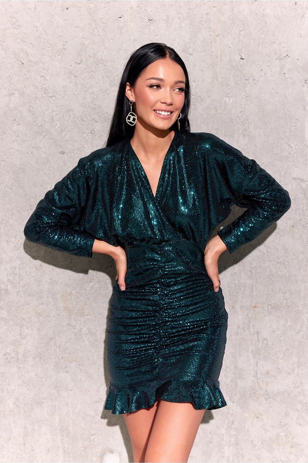 Stylish ruffled hem of the mini dress by Roco Fashion, emphasizing the fashionable design and exquisite details for a standout evening look.