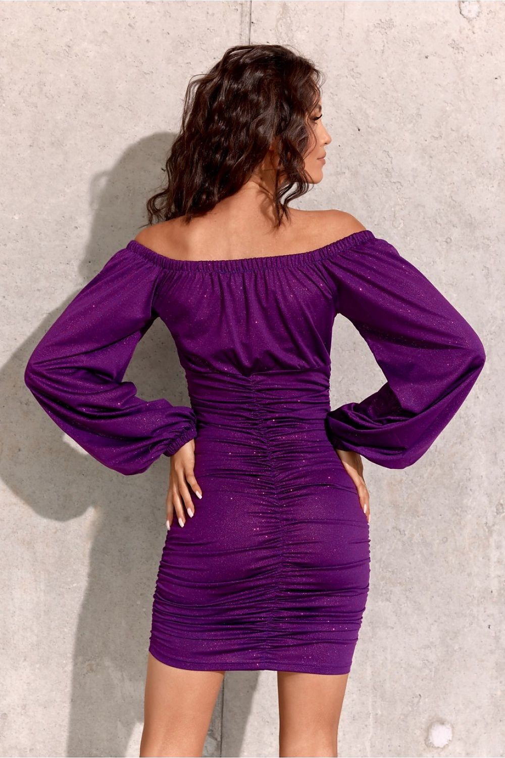 Side view of Roco Fashion's glamorous mini dress, featuring a covered zipper and flattering neckline, an ideal choice for fashionable women.