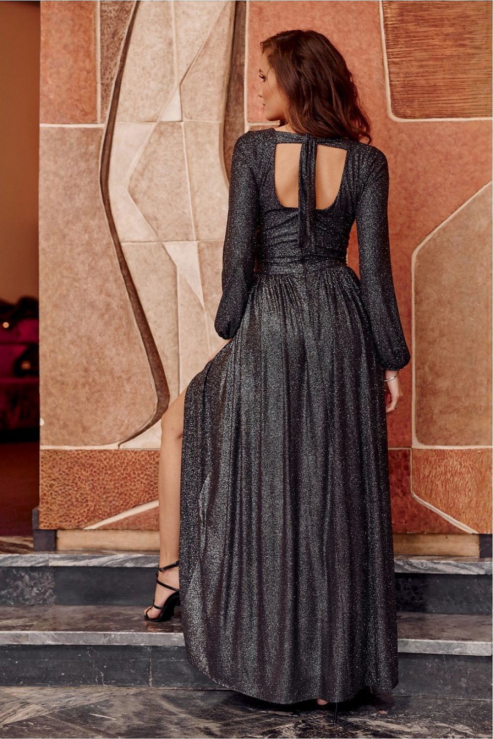 Sophisticated back view of Roco Fashion's brocade maxi dress showcasing decorative binding and a sensual cutout, ideal for weddings and celebrations.