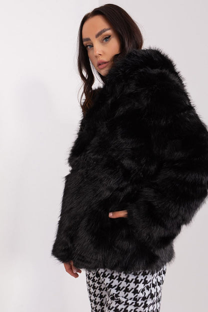 Model wearing an AT luxurious polyester fur jacket, featuring a hood and pockets, representing elegance for casual and special occasions.