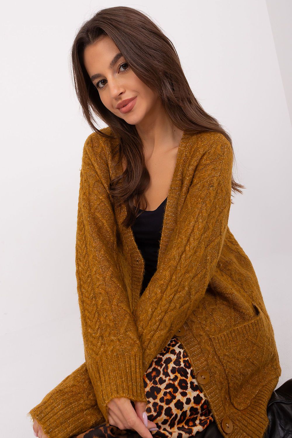 A model wearing the Elegant V-Neck Cardigan by AT, paired elegantly with jeans, highlighting its versatile style.