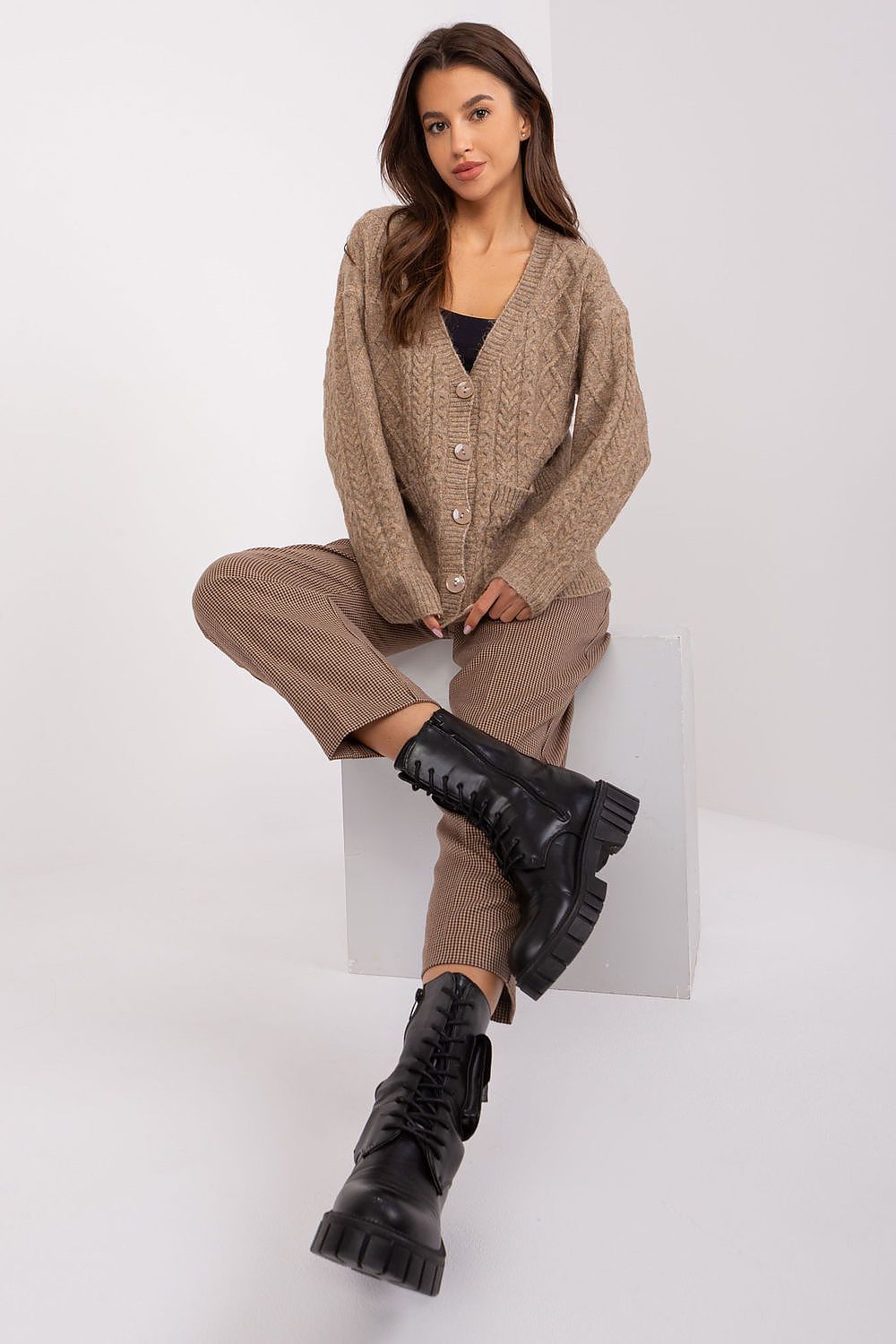 Model elegantly dressed in the V-Neck Cardigan by AT, highlighting its flattering silhouette and upscale variegated fabric.