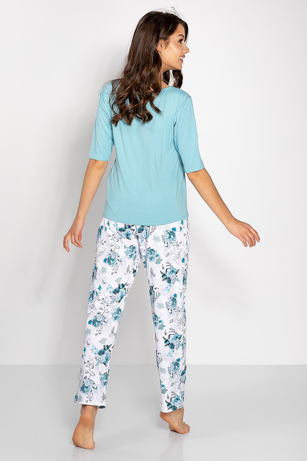Chic and sophisticated two-piece women's pyjamas by Momenti Per Me, showcasing a stylish half-round neckline and relaxed fit made from high-quality natural materials.