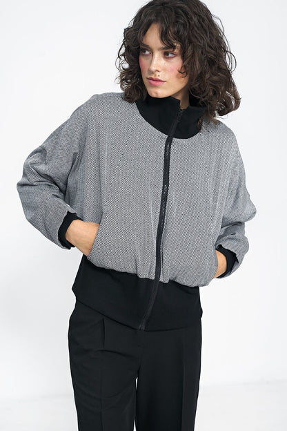 Timeless Minimalist Black Jacket by Nife worn with high-waisted pants, exemplifying chic autumn styling.