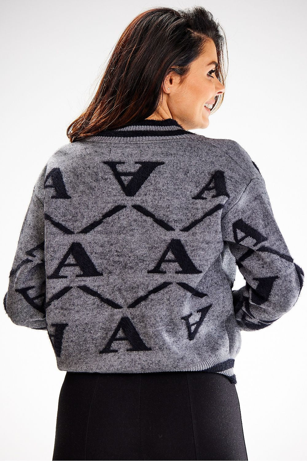 Chic close-up view of Awama's elegant two-tone short cardigan, highlighting the ribbed hem and luxurious nylon blend for ultimate comfort.