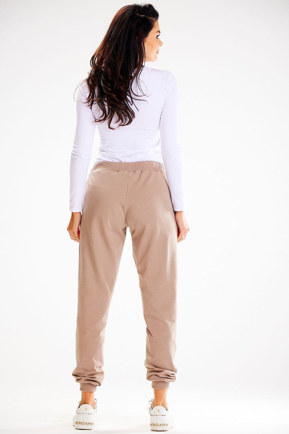 Chic Awama loose-fit tracksuit trousers showcasing an elastic waistband and sophisticated detailing, ideal for stylish lounging or casual outings.