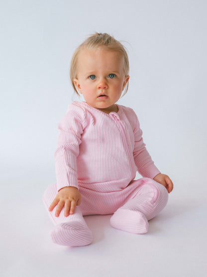 DreamBuy Sweet Pink Zip Sleepsuit laid out flat, emphasising its elegant style and comfort for babies and toddlers.
